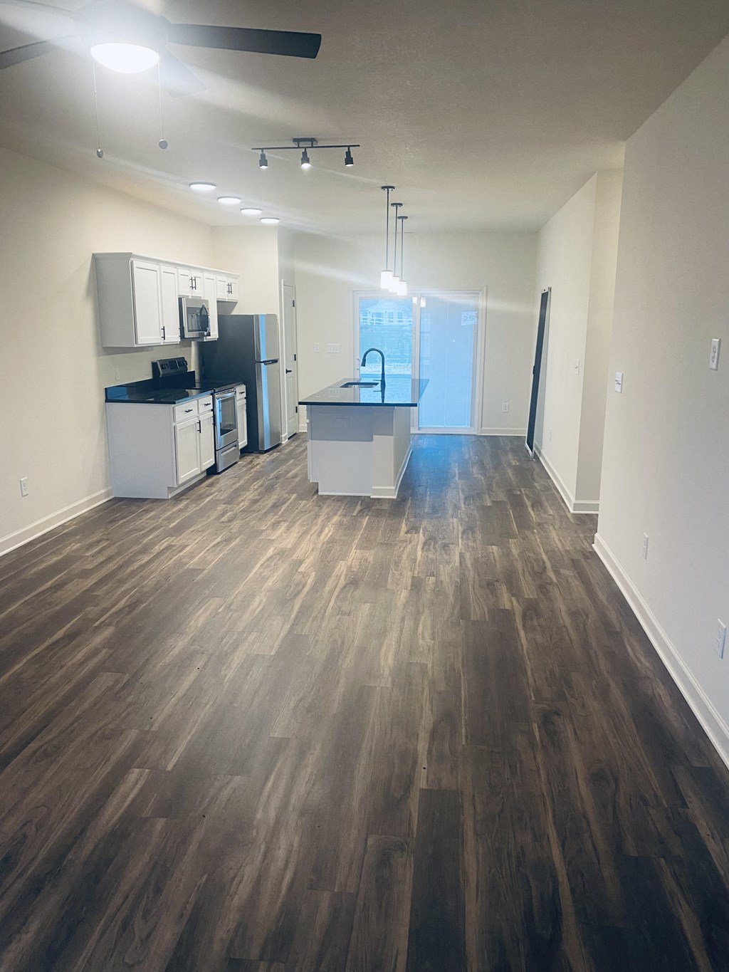 a kitchen and living room with wood flooring in an empty apartment at Concord Crossing, Lafayette, IN 47909