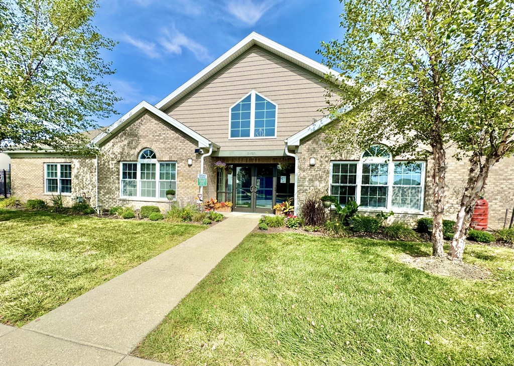 a house with a sidewalk and trees in front of it at Hawthorne Properties in Lafayette, IN 47905