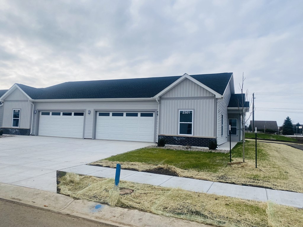 the front of a white house with two garage doors at Concord Crossing, Lafayette, IN 47909