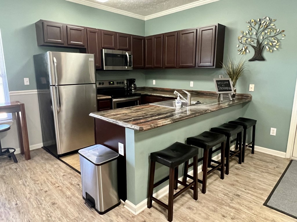 a kitchen with stainless steel appliances and a bar with stools at Shenandoah Properties in Lafayette, IN 47905