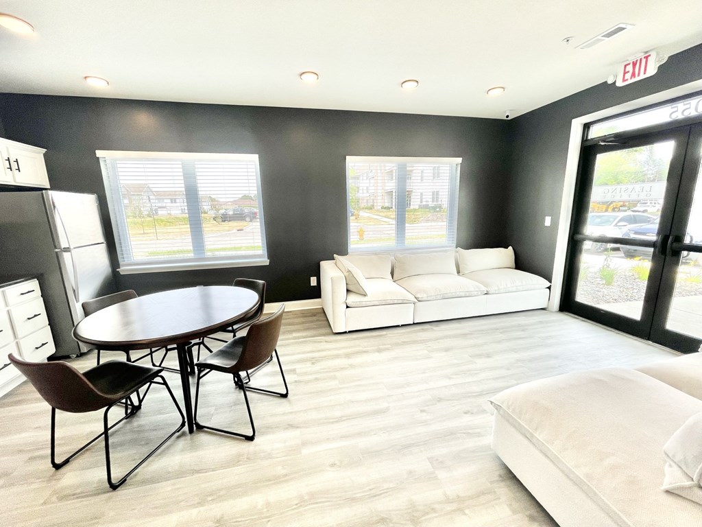 a living room with a couch a table and chairs at Murdock Gardens Apartments, Lafayette, IN 47904