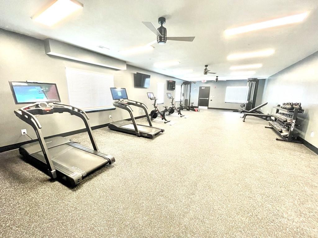 a large fitness room with treadmills and other exercise equipment at Murdock Gardens Apartments, Lafayette, IN 47904