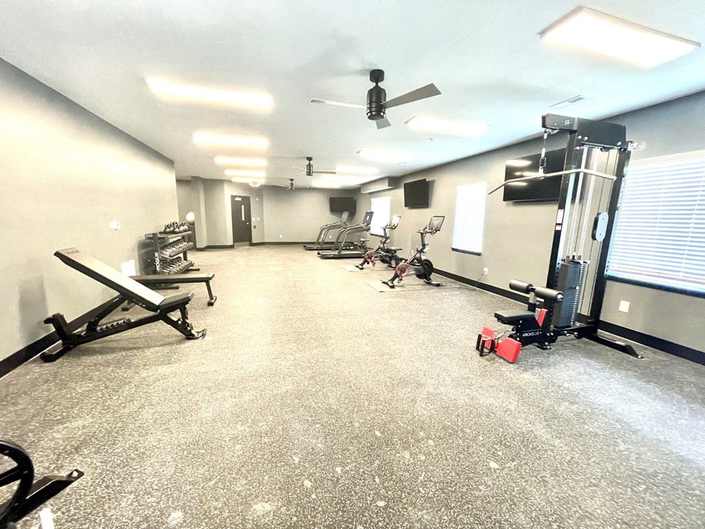 a large fitness room with exercise equipment and a ceiling fan at Murdock Gardens Apartments, Lafayette, IN 47904