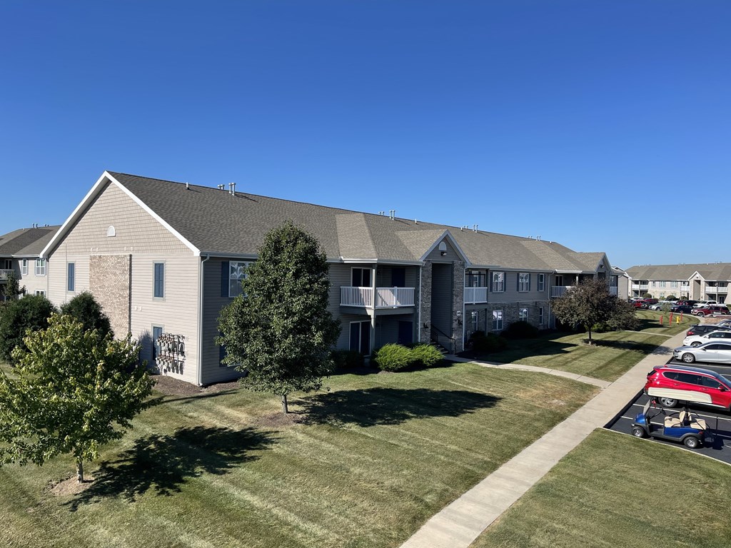 an aerial view of an apartment building with grass and trees at Hawthorne Properties in Lafayette, IN 47905
