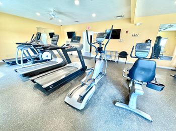 A gym with treadmills and exercise bikes.