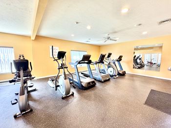 A spacious gym with a variety of exercise equipment.