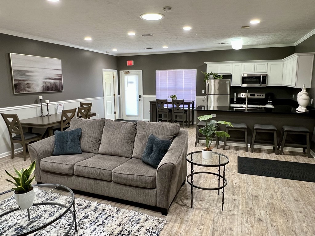 A living room with a grey couch and a coffee table.