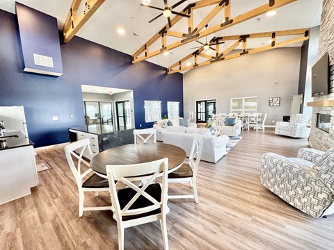 A spacious living room with a dining table and chairs.