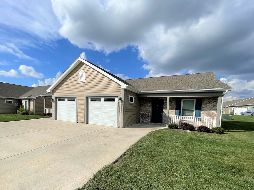 a house with two garage doors and a driveway at Hawthorne Properties in Lafayette, IN 47905