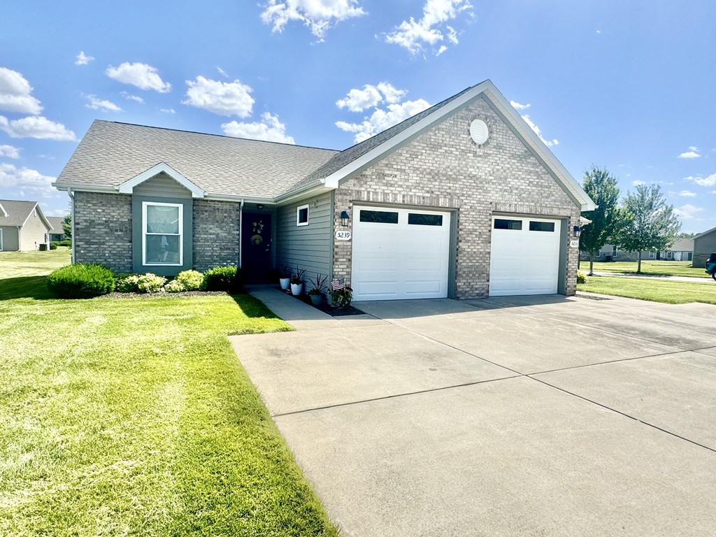 a gray brick house with a white garage door at Hawthorne Properties in Lafayette, IN 47905