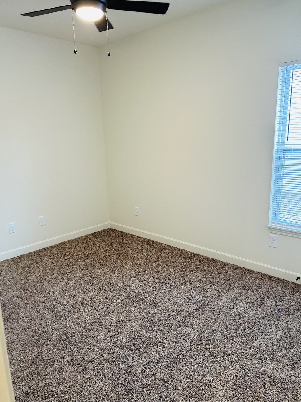 an empty room with carpet and a ceiling fan at Concord Crossing, Lafayette, IN 47909