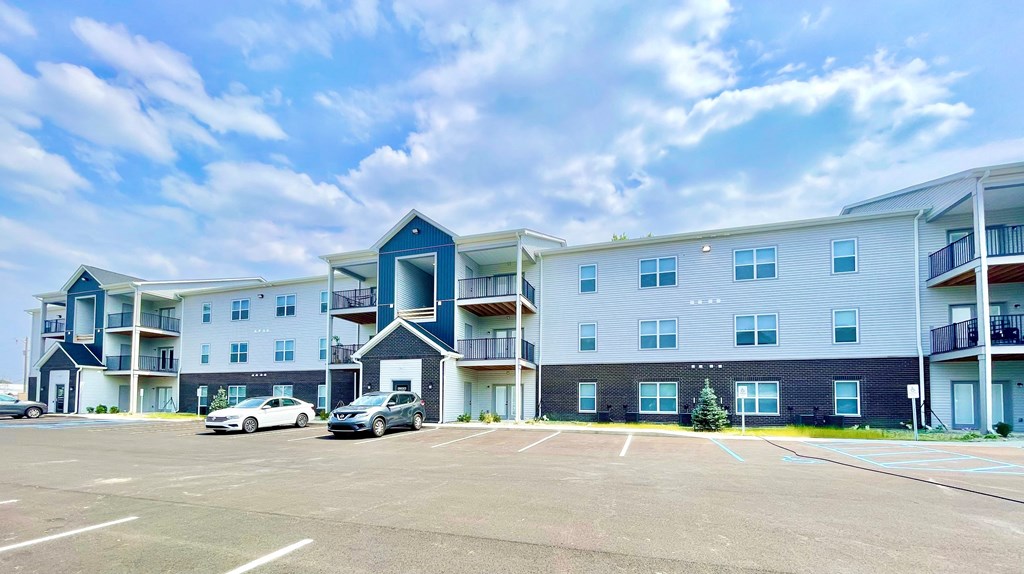 a large building with a parking lot in front of it at Murdock Gardens Apartments, Lafayette, IN 47904