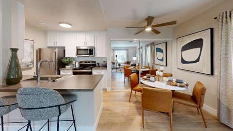 A modern kitchen with a dining table and chairs.