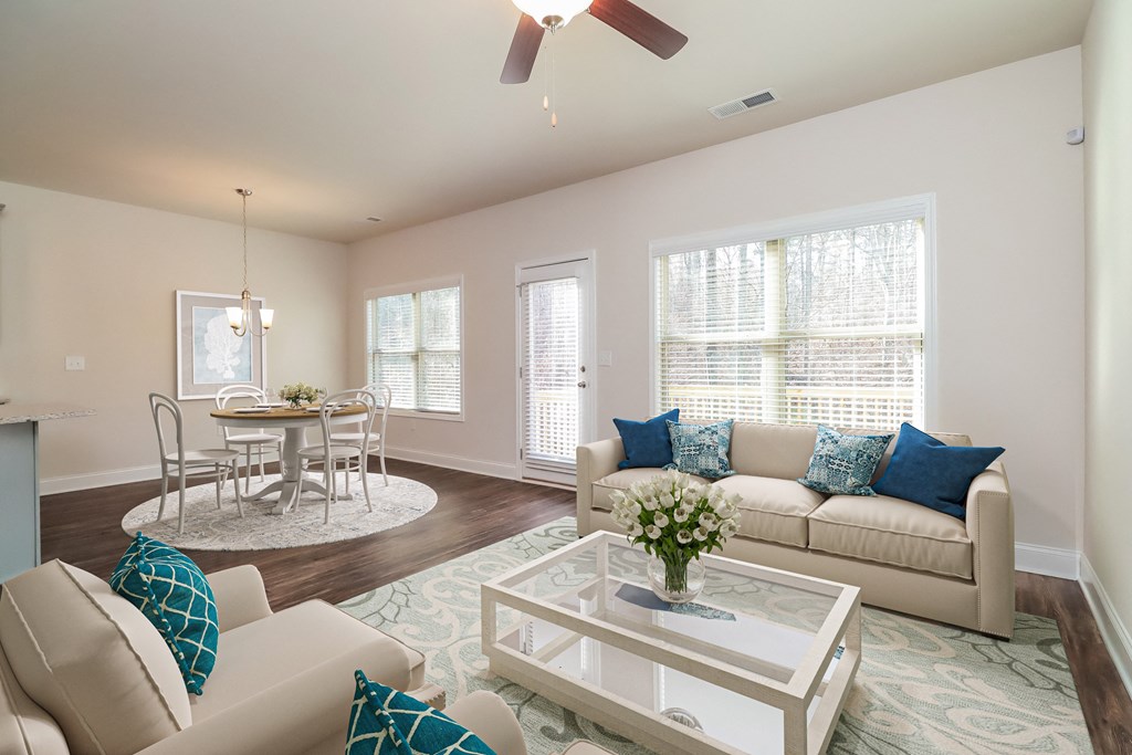 a living room and dining room with couches and a coffee table