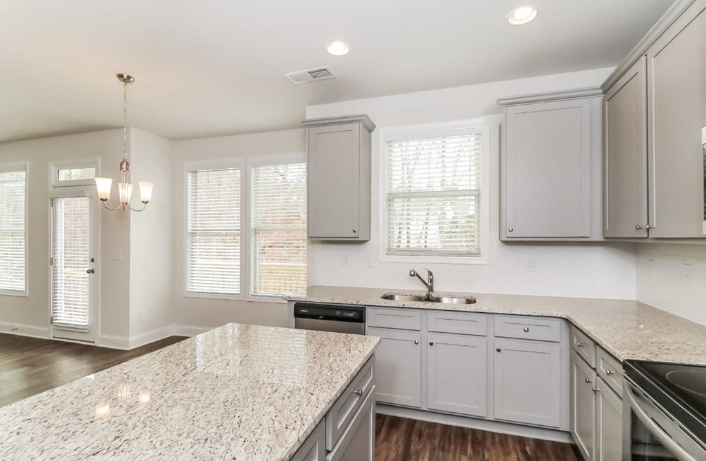 a kitchen with white cabinets and a counter top