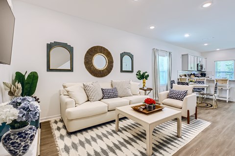 A living room with a white sofa and a coffee table.