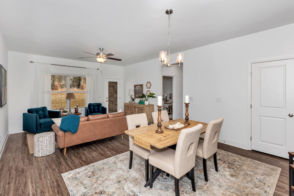 A dining room with a wooden table and chairs.