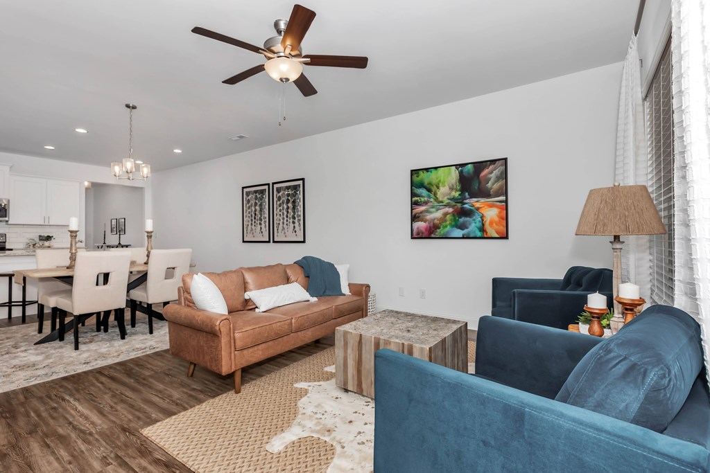 A living room with a brown couch and a blue couch.