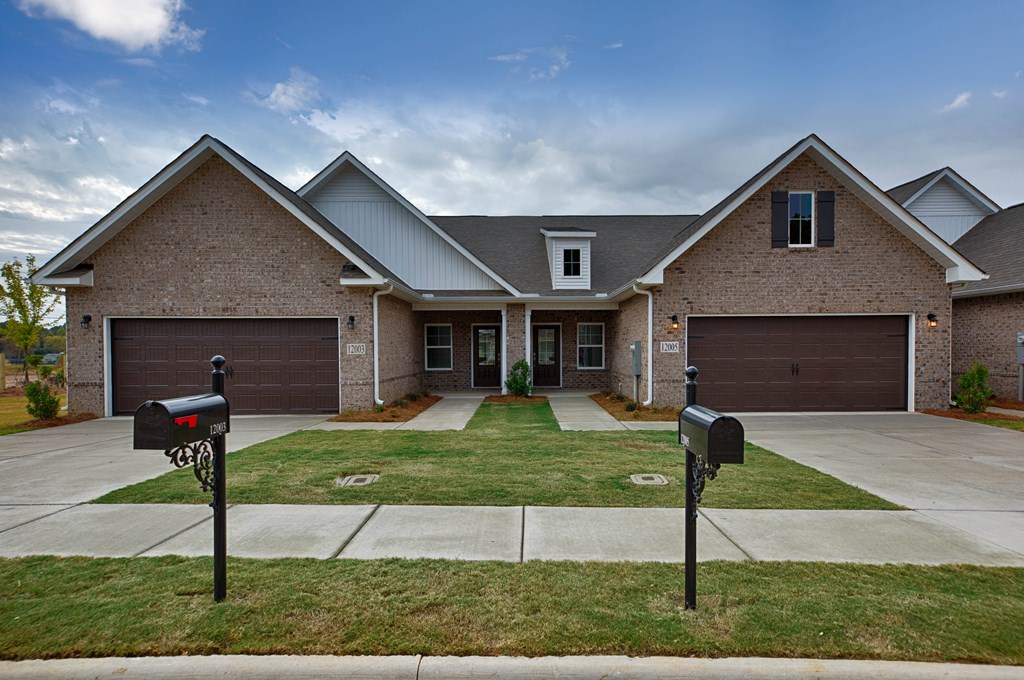 A house with a grey roof and a brown brick exterior.