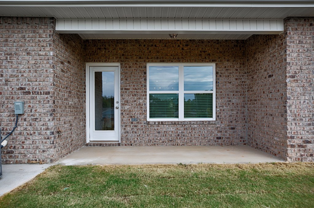 A house with a white door and window with blinds.
