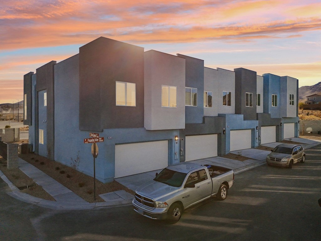 A modern building with a car parked in front.