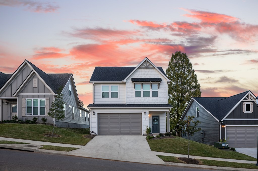 A row of houses with a tree in front of the first house.