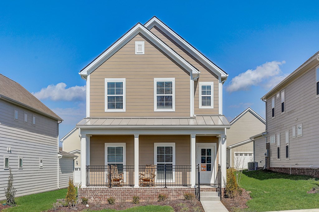 A house with a front porch and a small front yard.