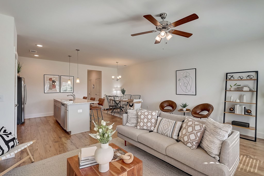 A living room with a grey couch and a wooden coffee table.