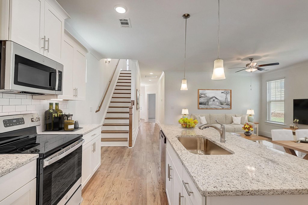 A kitchen with a stove top oven and a microwave.