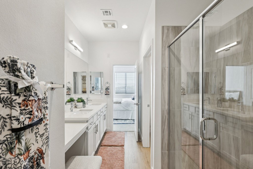 A bathroom with a walk-in shower and a large mirror.