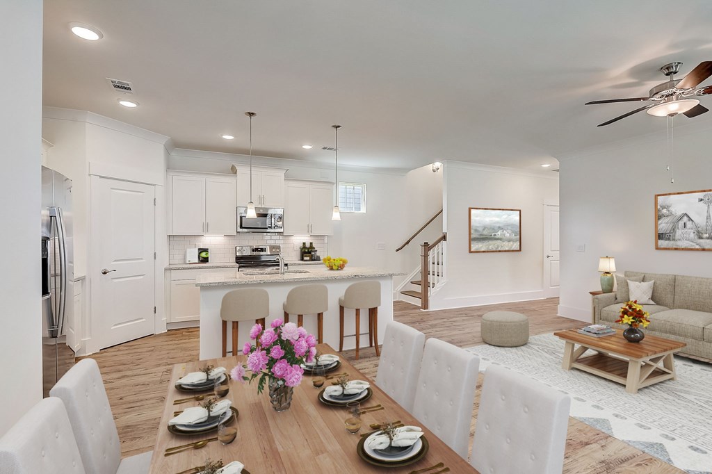 A modern dining room with a wooden table set for a meal.