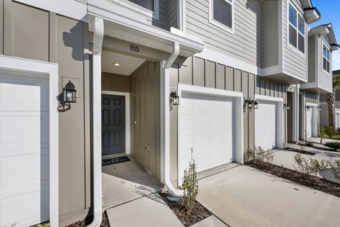 A house numbered 85 with a grey and white exterior.
