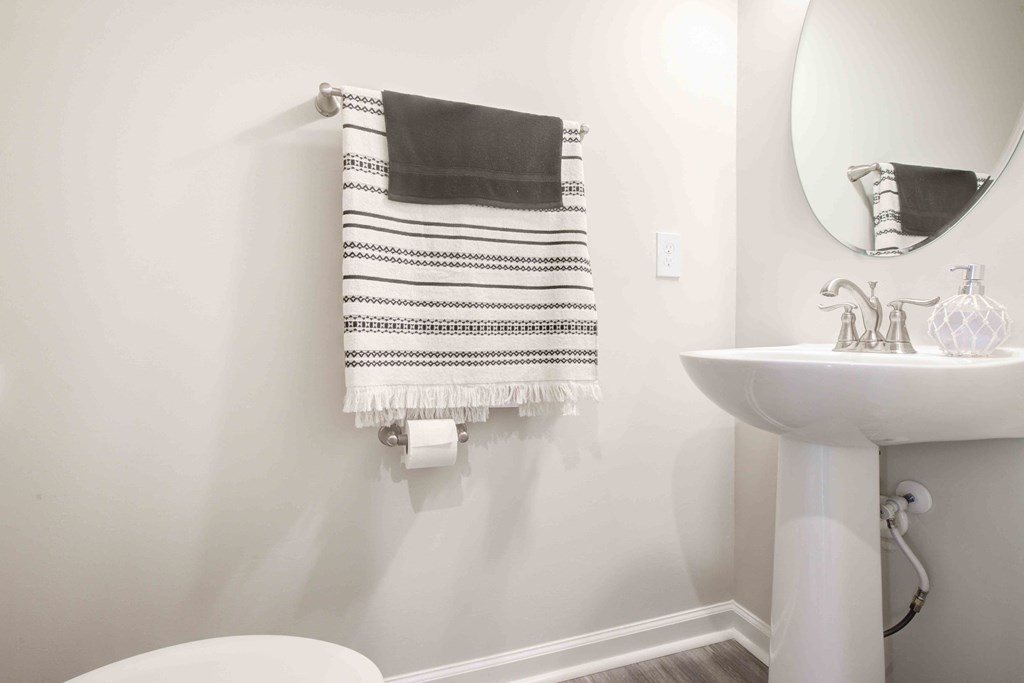 Luxurious bathroom featuring a modern towel rack and elegant fixtures with sophisticated finishes