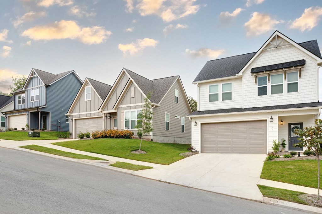A row of houses with garages on the side.