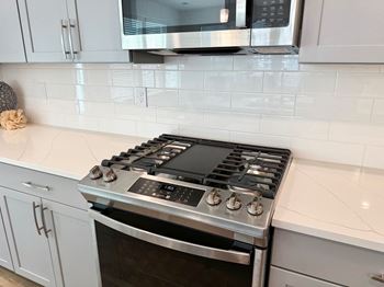 a kitchen with a stove and a microwave