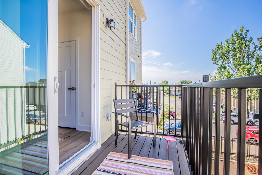 a patio with a chair on a balcony