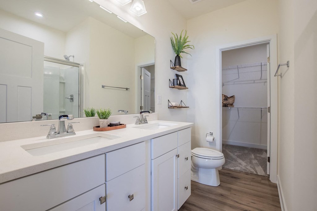 a bathroom with two sinks and a toilet
