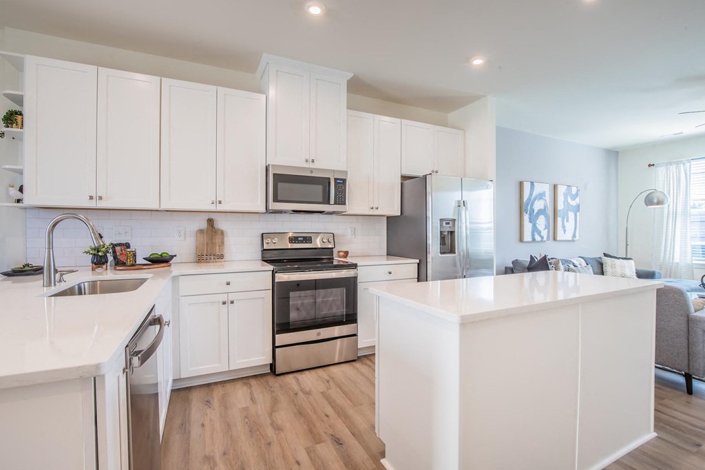 a kitchen with white cabinets and a white counter top