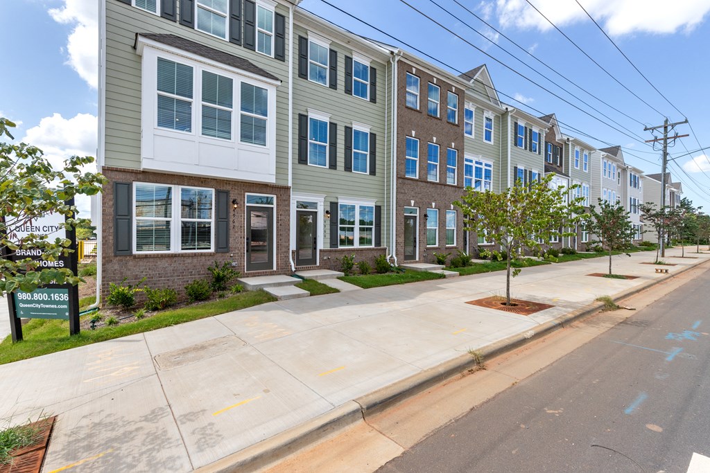 a row of apartment buildings on the corner of a street
