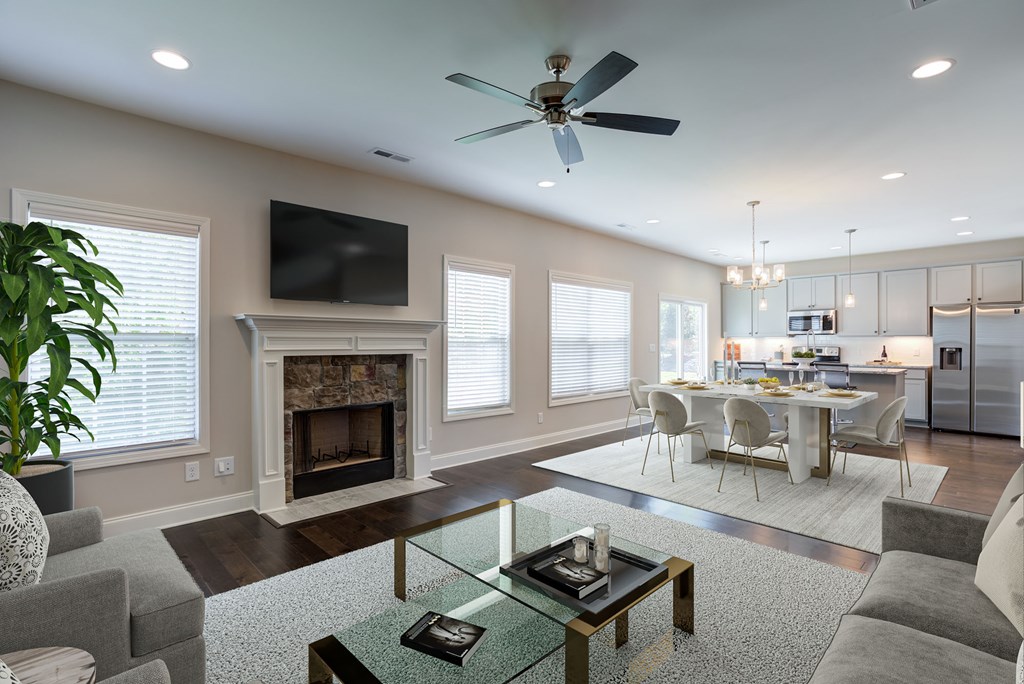 A modern living room with a fireplace and a television.