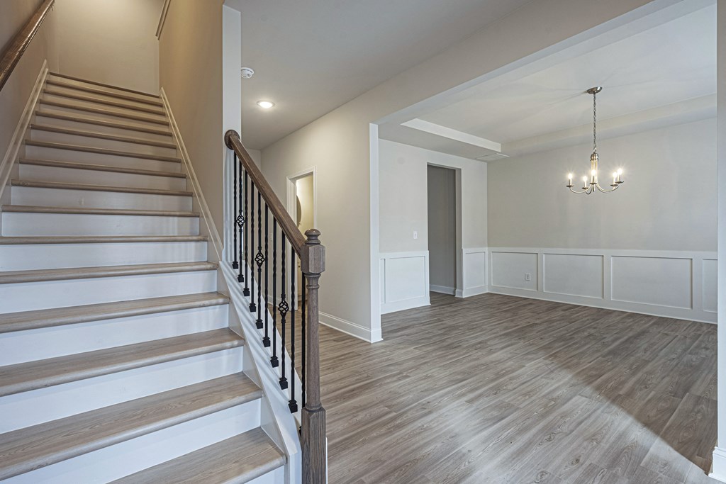 the landing of a staircase in a new home with wood floors and white walls