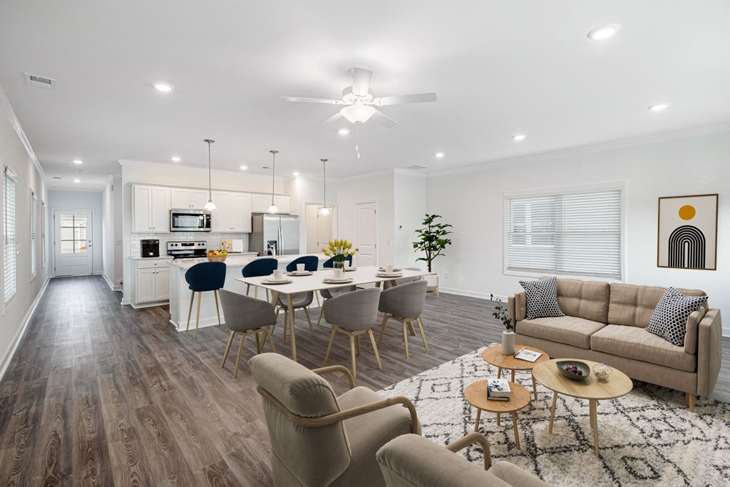 a living room with a couch and a table with chairs