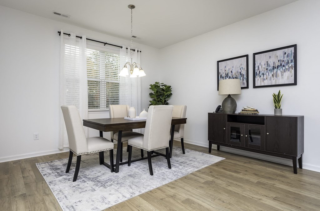 a dining room with a table and chairs