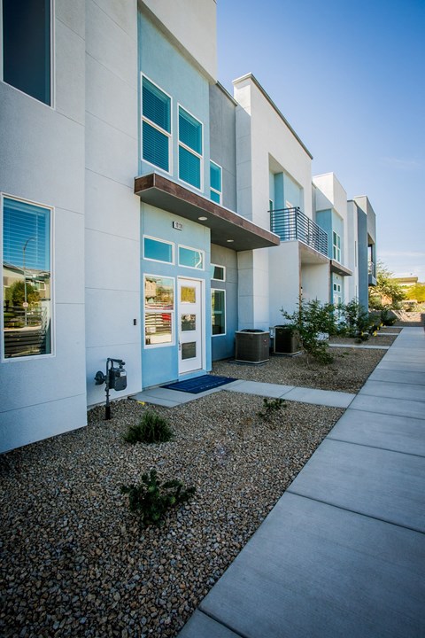 A modern building with a blue door and windows.