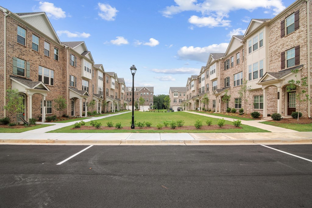an empty parking lot in front of an apartment building