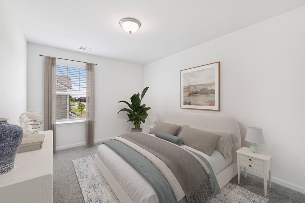 A bedroom with a large bed and a painting on the wall.