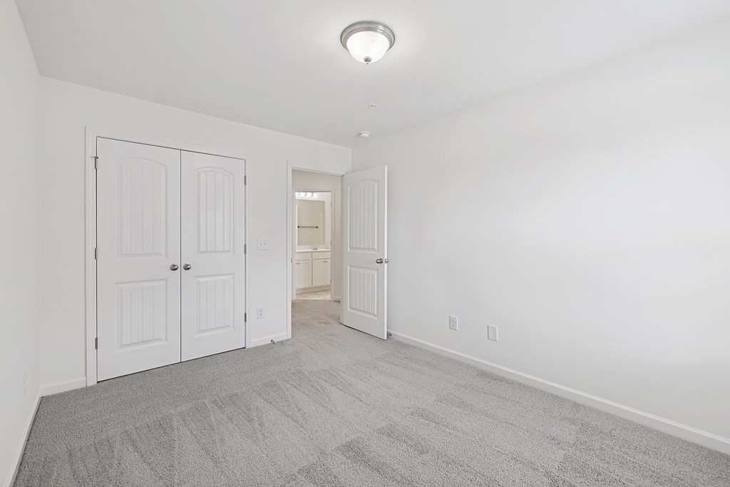 A room with a carpeted floor and white walls.