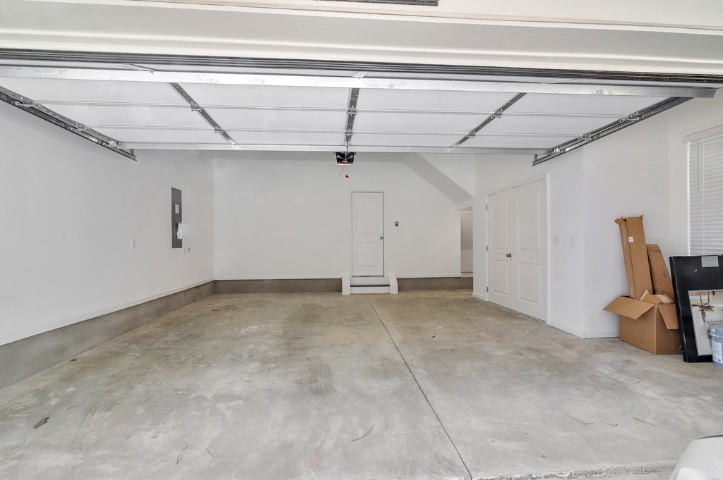 an empty garage with white walls and a white door
