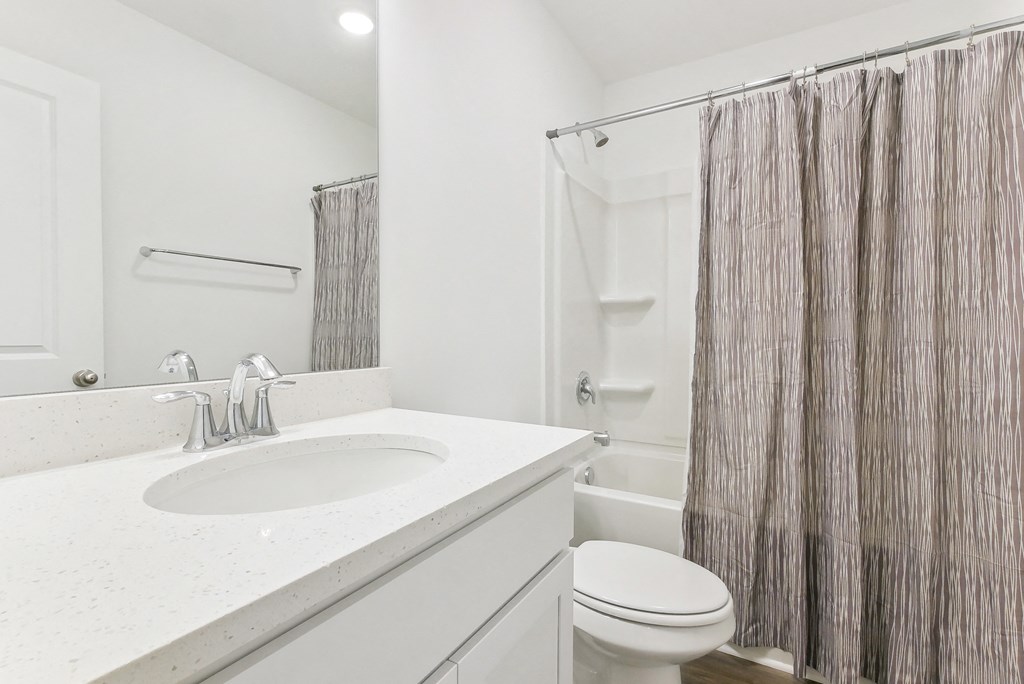 Sleek bathroom with soaking tub and shower combination