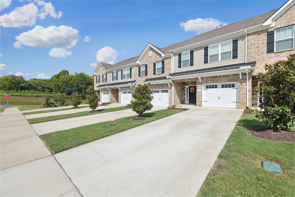 A large house with a driveway in front.